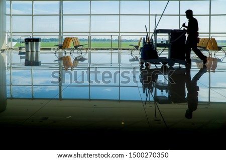 Silhouette of janitor cleaning service male guy on duty in artistic shot Foto stock © 