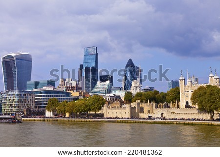 London view of Tower of London and City of London skyscrapers : Gherkin, Leadenhall, Walkie Talkie, on a sunny summer day, taken over the Thames River