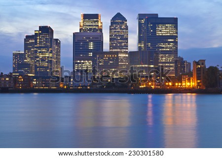 London Docklands business district skyline over Thames river at twilight