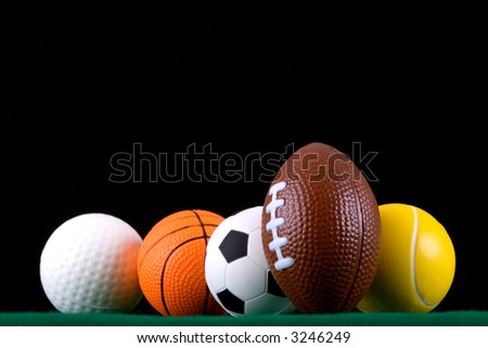 Miniaturized sport balls over black background. Shallow depth of field. Focus is on the front.