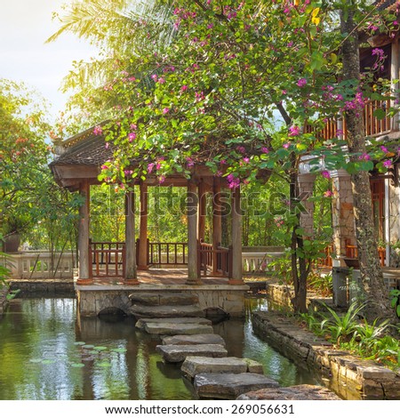 asian tropical garden with traditional bridge and buildings, Vietnam