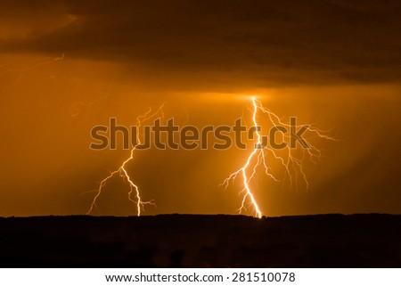 Double lightning in red sky during stormy weather