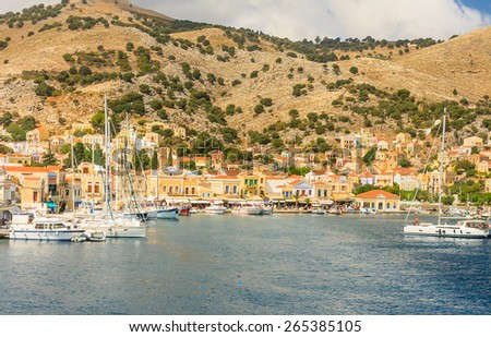 SYMI, GREECE - AUGUST 02, 2014: Fishing boats moored in Yialos harbour on August 02, 2014 on Symi island, Greece. Yialos, the main harbour on Symi, is a popular destination for day trips from Rhodes.