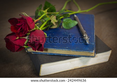Roses on old books and glasses.