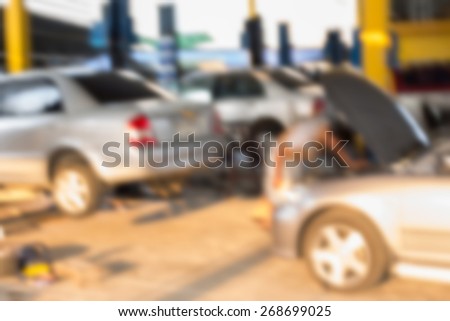 Blurred background : Car technician repairing the car in garage.