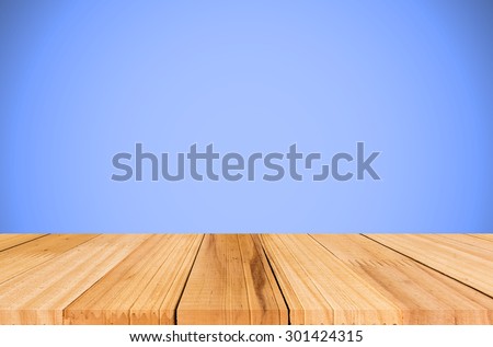 Wooden deck table on blue vintage background.