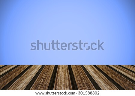 Wooden deck table on blue vintage background.