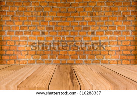 Grungy textured red brick and stone wall with warm brown wooden floor inside old neglected and deserted interior, masonry and carpentry brickwork concept for your photomontage or product display.