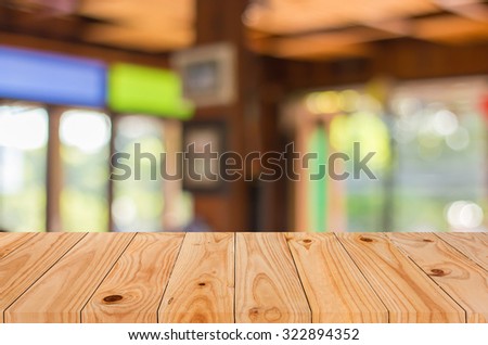 Selected focus empty brown wooden table and Coffee shop blur background with bokeh image, for product display montage.