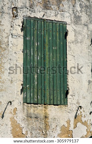 Green painted window shutters on French home