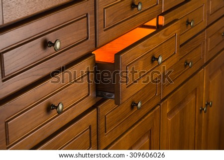 orange light from drawer, concept of secret,   storage of valuable objects