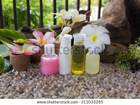 mini set of bubble bath and shower gel on natural fresh background and flowers with relax feeling