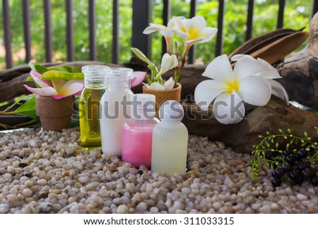 mini set of bubble bath and shower gel on natural fresh background and flowers with relax feeling