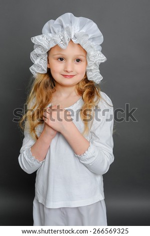 Girl in dress rustic vintage on a gray background folded her arms