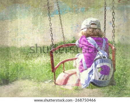 Child on a swing with a backpack at wall background. Old image color style.