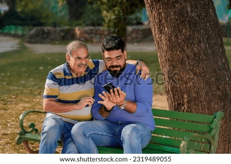 Similar – Image, Stock Photo Father and son using digital tablet together at night in bed