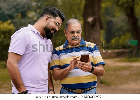 Similar – Image, Stock Photo Father and son using digital tablet together at night in bed