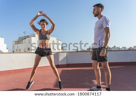 Image, Stock Photo Sportswoman jumping on terrace during training