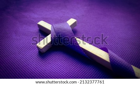 Good Friday, Lent Season and Holy Week concept - A Christian cross on purple background. Conceptual Stockfoto © 