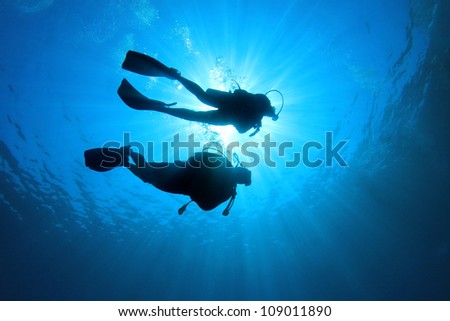 Couple of scuba divers set out on an underwater adventure