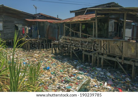 KOTA KINABALU, MALAYSIA - APRIL 26 2014: Pollution in shanty town. Photo showing environmental problem of garbage build up in poor shanty town due to lack or refuse collection or recycling services.