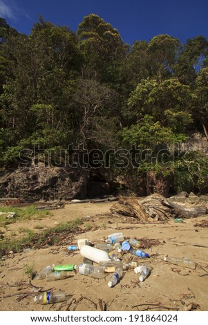 BAKO NATIONAL PARK, MALAYSIA - MAY 09 2014: Plastic pollution on remote tropical beach. Photo shows problem of plastic pollution in oceans, with non-biodegradable plastics drifting onto nature areas.