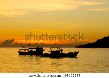 Fishing Boats at sunset on sea
