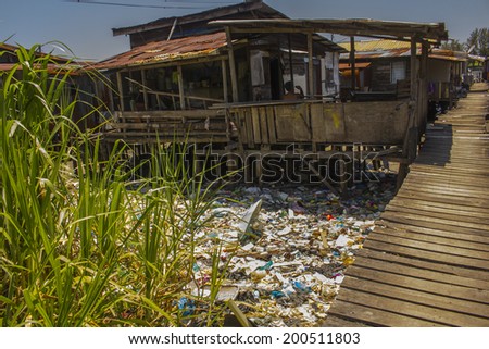 KOTA KINABALU, MALAYSIA - APRIL 26 2014: Pollution in shanty town. Photo showing environmental problem of garbage build up in poor shanty town due to lack or refuse collection or recycling.