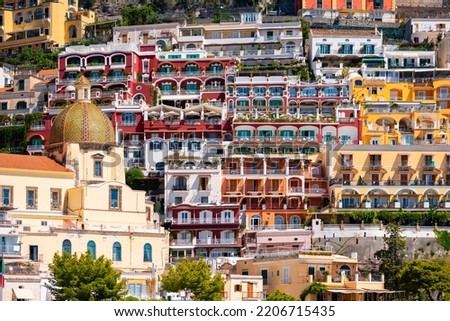 Positano on the famous Amalfi Coast in Campania Italy. Picturesque historic village with colorful houses and church built on the steep coastline. Summer atmosphere in popular tourist destination.  Foto d'archivio © 