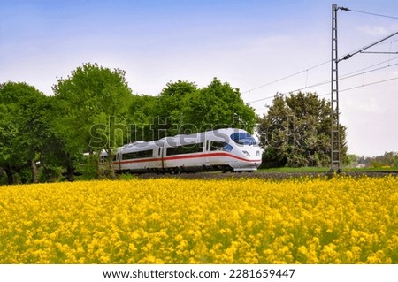 Image, Stock Photo Passenger train and rapeseed field. Spring landscape at sunrise