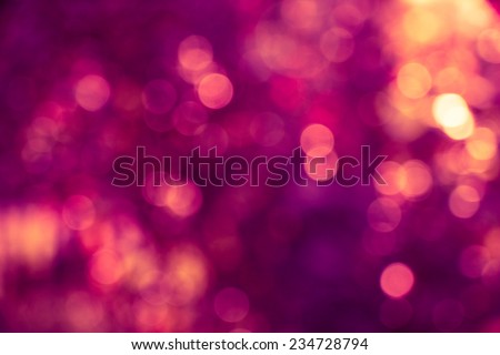 Abstract defocused background with purple and gold circular blurry bokeh