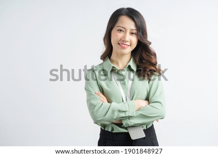 Portrait of the beautiful asian businesswoman with arms crossed on a white background
