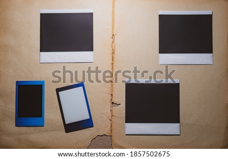 Blank photo frames on book background as template. Top View of photo frame, memory of a trip or adventure. Photo card with space for your logo or text. 