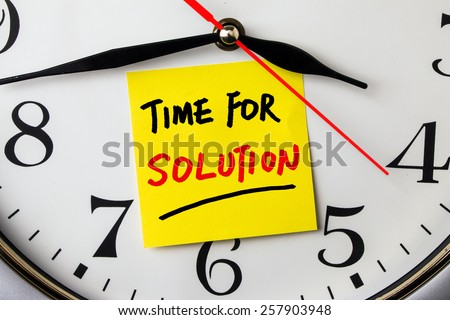 time for solution on post-it stuck to a wall clock