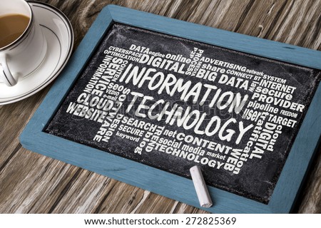 information technology concept with related word cloud handwritten on blackboard