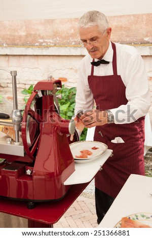 Italian man slicing ham