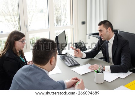 Co-workers discussing business plan in office