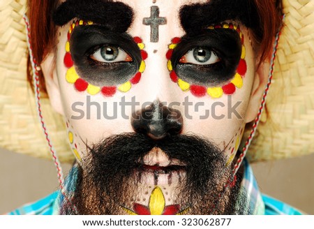 Young woman portrait. Face with fun make up for Day of the Dead celebration. Unique face art. Posing beautiful model.