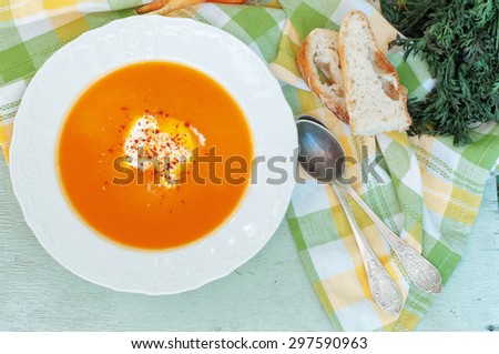 Carrot-Apple Soup on a light green wood background