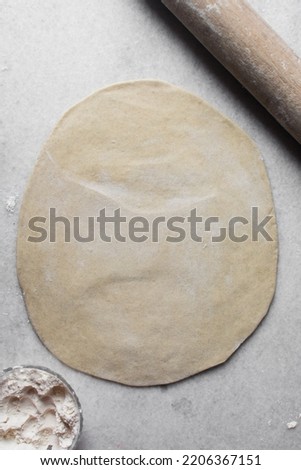 Similar – Image, Stock Photo Dough rolled out on a green background. Homemade pie crust and rolling pin. Baking concept