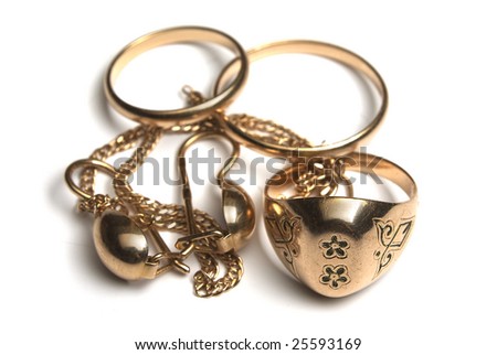 heap of gold jewelry isolated on white. Rings, ear ring and bracelet