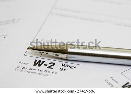 Business metal pen  on W-2 tax form