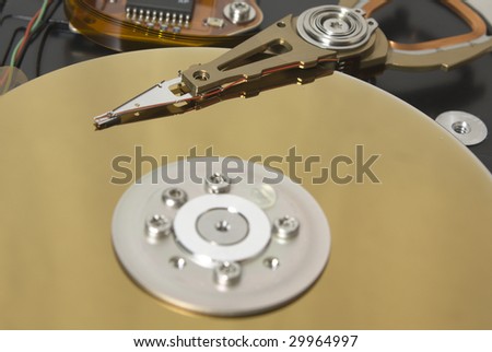 Closeup of the platters and read/write head of a computer hard drive