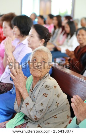 UDONTHANI THAILAND- Dec 6: old lady waiting for celebrating mass during Our Lady Of Perpetual Help parish\'s celebration on Dec 6, 2014 in UDONTHANI THAILAND