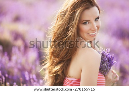 Beautiful young woman with lavender flowers, happy girl in lavender field, spa and aromatherapy, lavender background, series. sunset soft focus