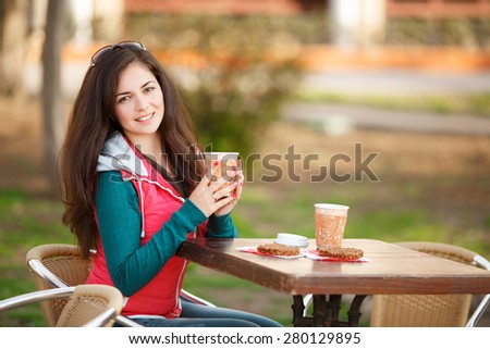 Beautiful woman drinking coffee outdoors, happy young girl with cup of tea at street cafe, pretty female in city cafe, female with espresso at restaurant, sofl light, series.
