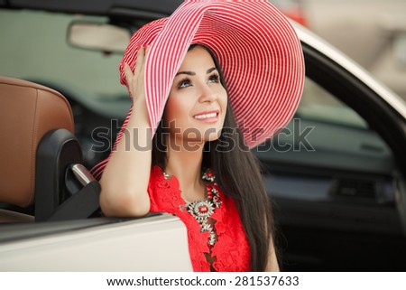 Fashionable woman smiling in car beautiful young girl portrait summer vogue female driver, sexy fashion woman model in luxury car, series