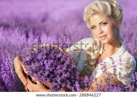 Beautiful young woman with lavender flowers, smiling girl in lavender field enjoy nature, happy blonde female in lavender outdoor portrait France woman in provence health care and aromatherapy concept