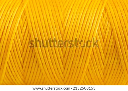 A coil of yellow thread. Spool of colored threads on a white background. Waxed sewing thread for leather crafts. Foto stock © 