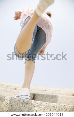 The woman running up the stairs